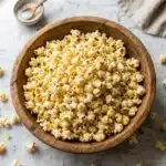 homemade popcorn recipe in a wooden bowl with golden fluffy kernels
