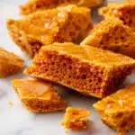 honeycomb recipe golden shards showing airy bubble structure on white marble