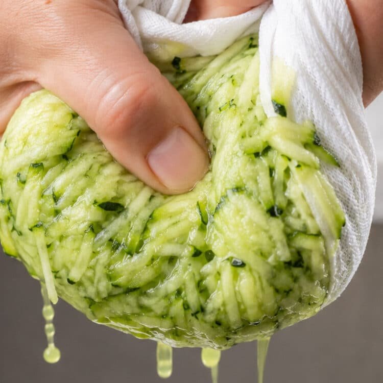 zucchini slice recipe squeezing grated zucchini dry in a tea towel